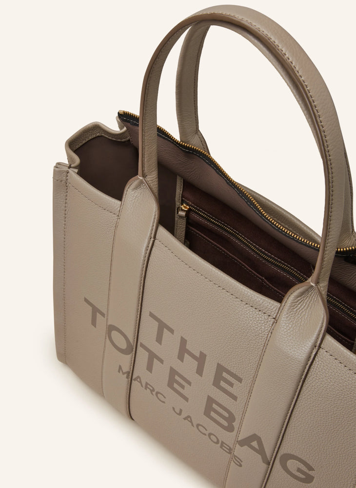 Marc Jacobs Shopper Tote Bag Leather Beige displayed on a light background, showcasing its spacious design and stylish look.