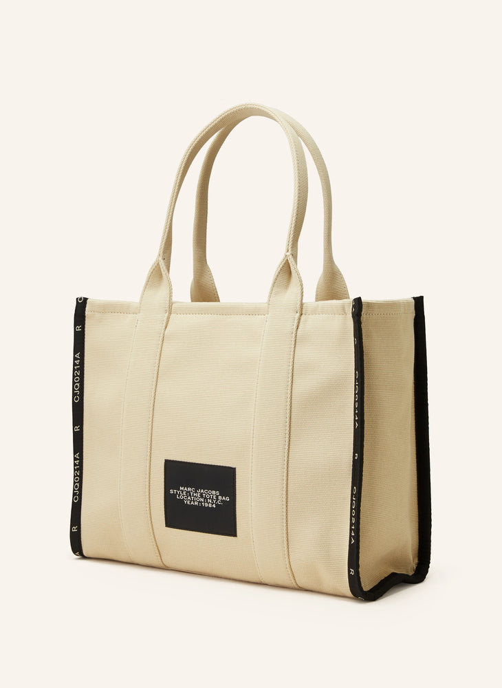 Marc Jacob Canvas Shopper Tote Bag with large black text on a beige canvas background.