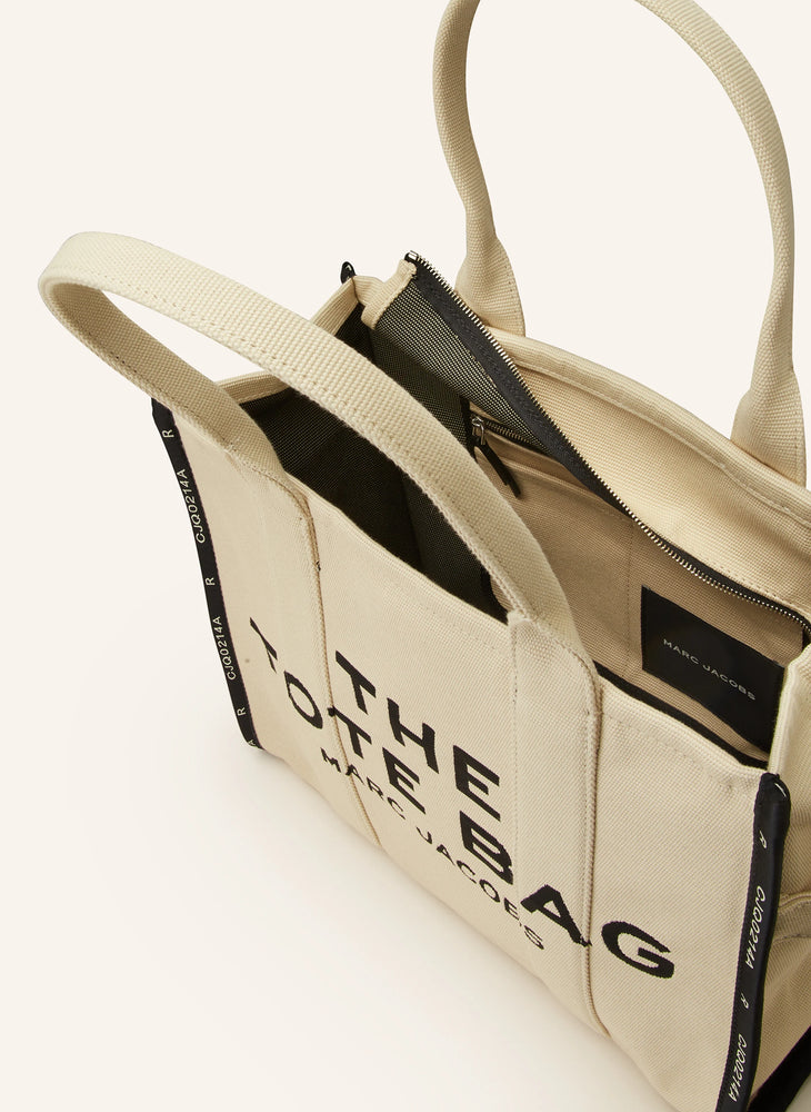 Marc Jacob Canvas Shopper Tote Bag with large black text on a beige canvas background.