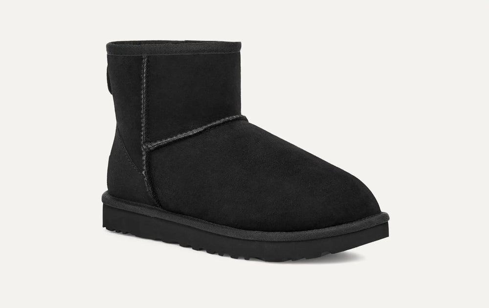 Black suede boot on a white background. UGG Women's Classic Cozy Sheepskin Mini II Boot