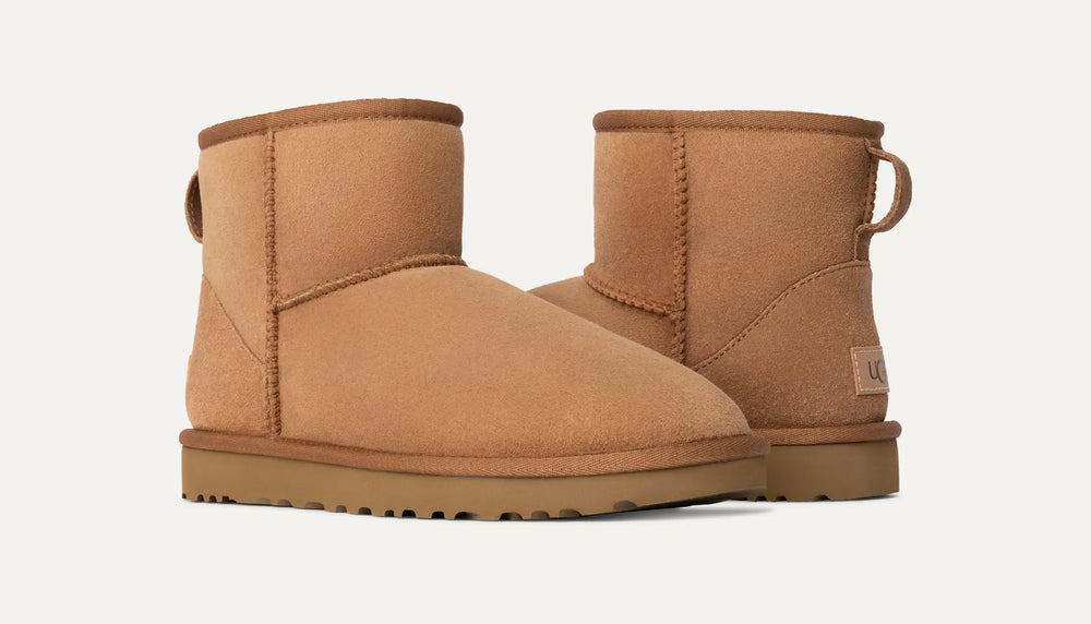Pair of tan suede boots in Volonka store. UGG Women's Classic Cozy Sheepskin Mini II Boot