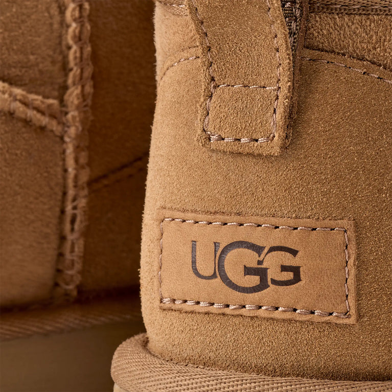 Close-up of a UGG label on a brown suede product.UGG Classic Ultra Mini Women's Warm Wool Snow Boots in volonka shop