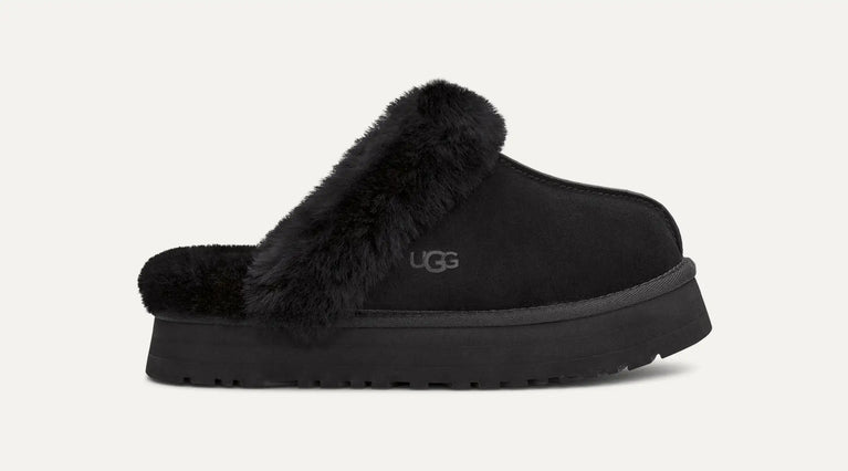 Black UGG slipper with fur trim on a white background. UGG Womens Disquette Cozy and Stylish Slippers