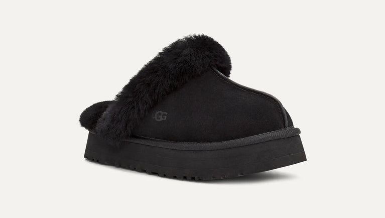 Black UGG slipper with fur trim on a white background. UGG Womens Disquette Cozy and Stylish Slippers