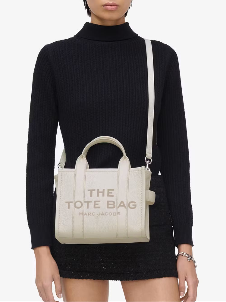 Marc Jacobs Shopper Tote Bag Leather White displayed on a clean background, showcasing its elegant design and craftsmanship.