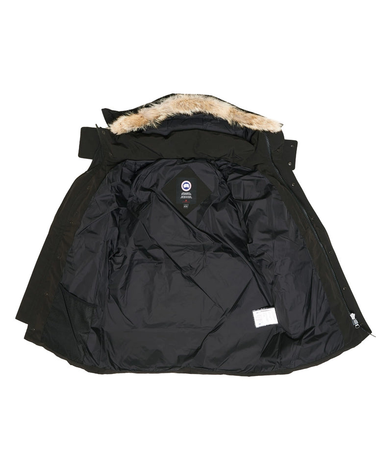 Black winter jacket with fur-lined hood on a white background. Canada Goose Wyndham Parka with Fur jacket