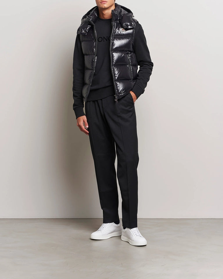 Man wearing a black outfit with a shiny vest. Moncler unisex Bormes down vest jacket