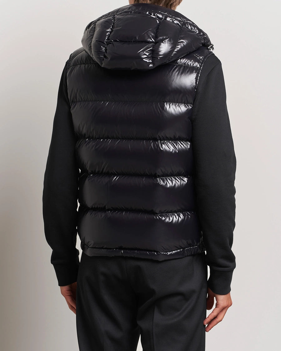 Women/ men Black puffer vest worn by a person. Moncler unisex Bormes down vest jacket
