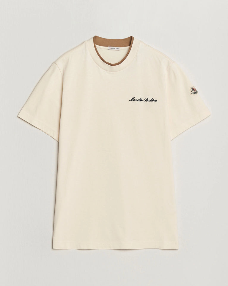 Moncler Men Signature Logo Tshirt displayed in Off white, featuring logo detail and contrasting neckline.