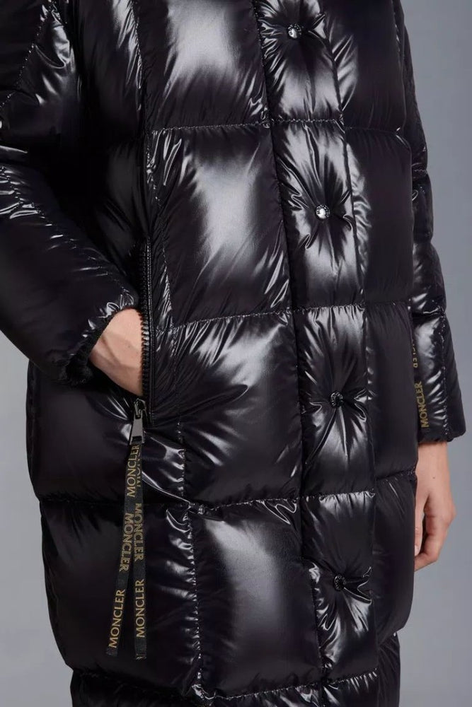 Black quilted jacket with brand logo on a gray background