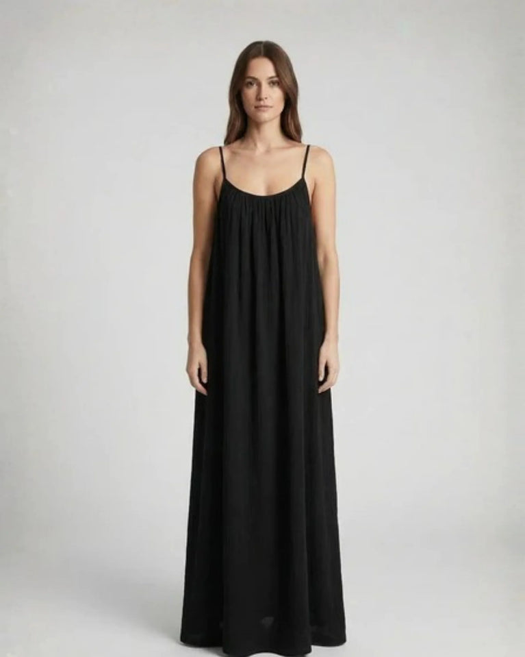 Woman wearing a Backless Loose Home Long Dress in black, showcasing a relaxed and stylish look.