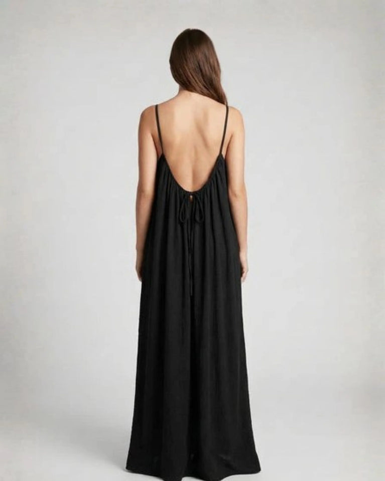 Woman wearing a Backless Loose Home Long Dress in black, showcasing a relaxed and stylish look.