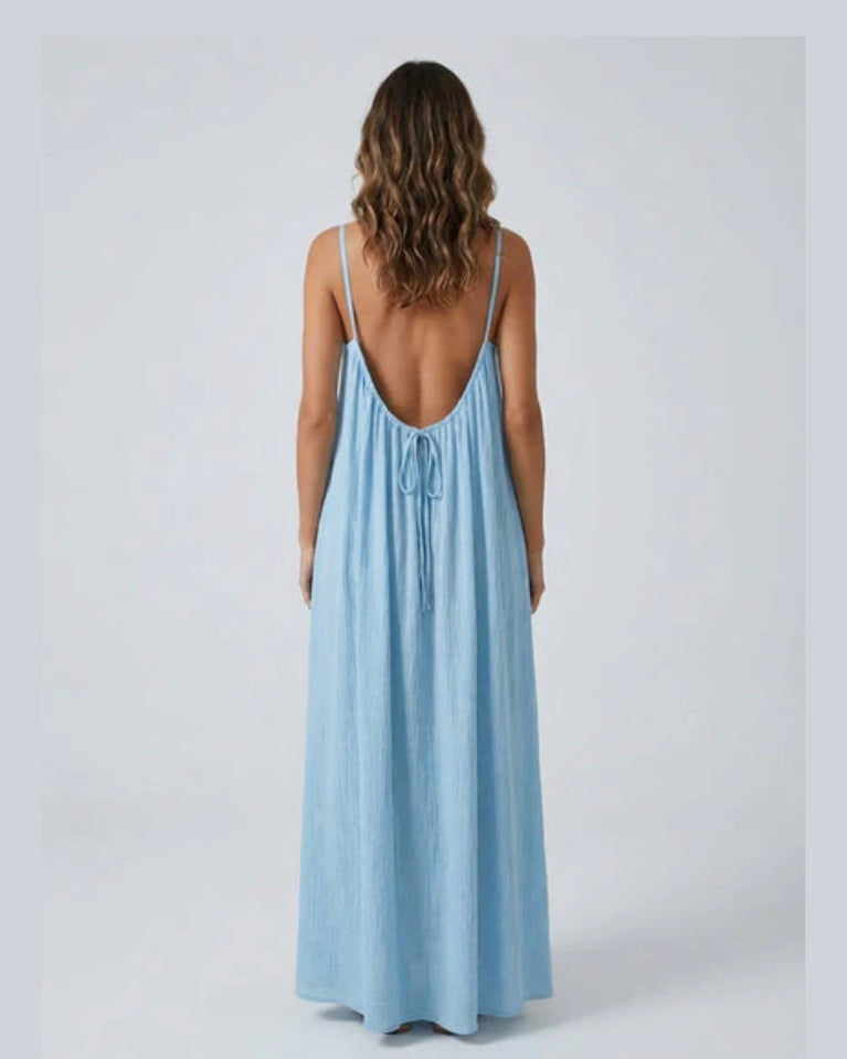Woman wearing a Backless Loose Home Long Dress in light blue, showcasing a relaxed and stylish look.