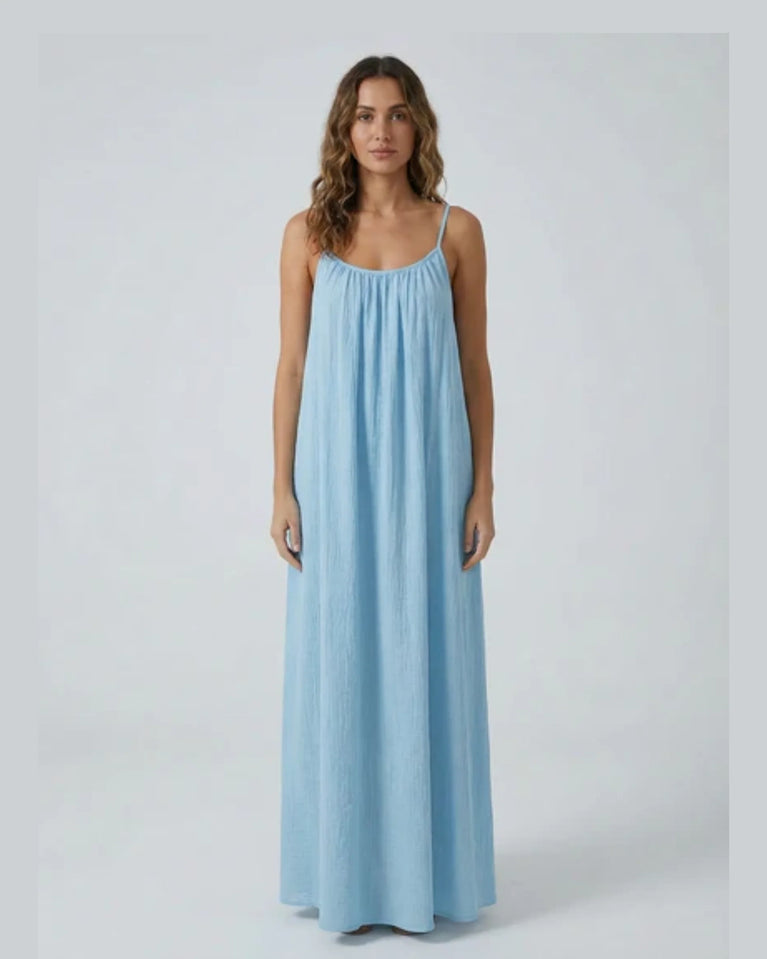 Woman wearing a Backless Loose Home Long Dress in light blue, showcasing a relaxed and stylish look.