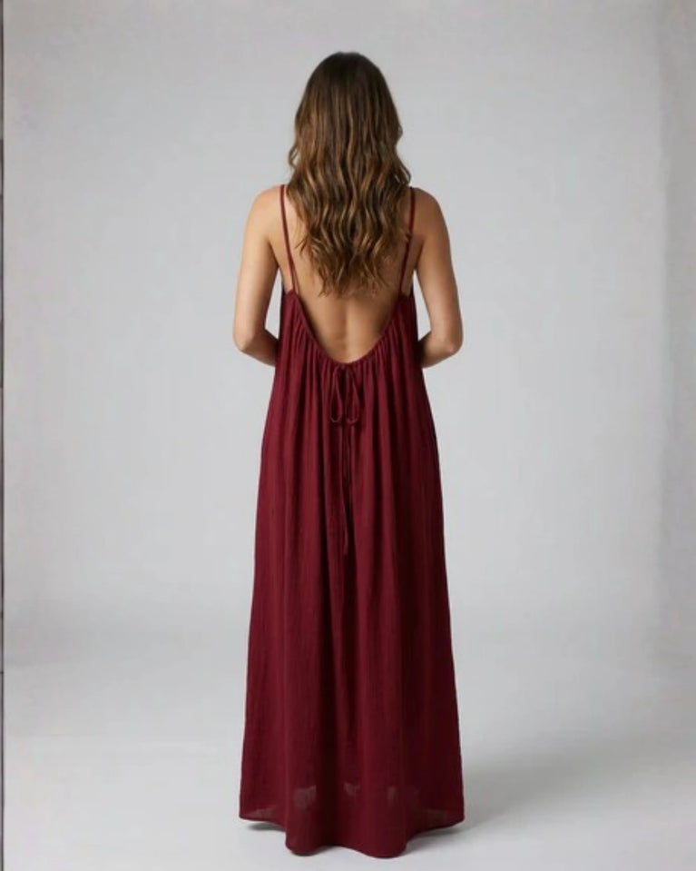 Woman wearing a Backless Loose Home Long Dress in burgandy, showcasing a relaxed and stylish look.