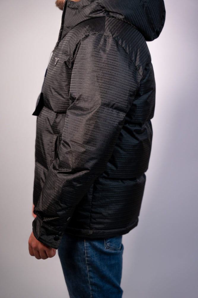 Person wearing a black puffer jacket. Prada Puffer Down Jacket Unisex