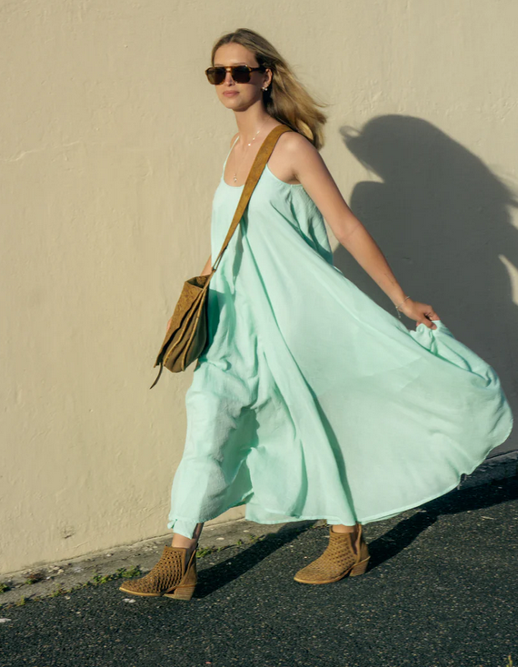 Woman wearing a Backless Loose Home Long Dress in mint green, showcasing a relaxed and stylish look.