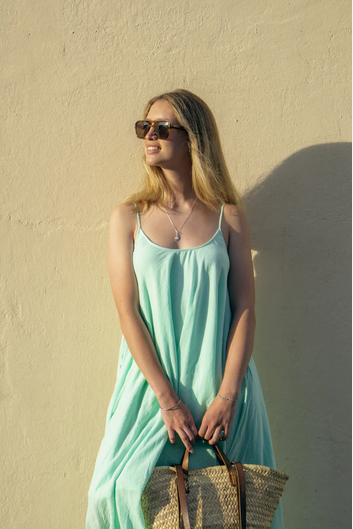 Woman wearing a Backless Loose Home Long Dress in mint green, showcasing a relaxed and stylish look.