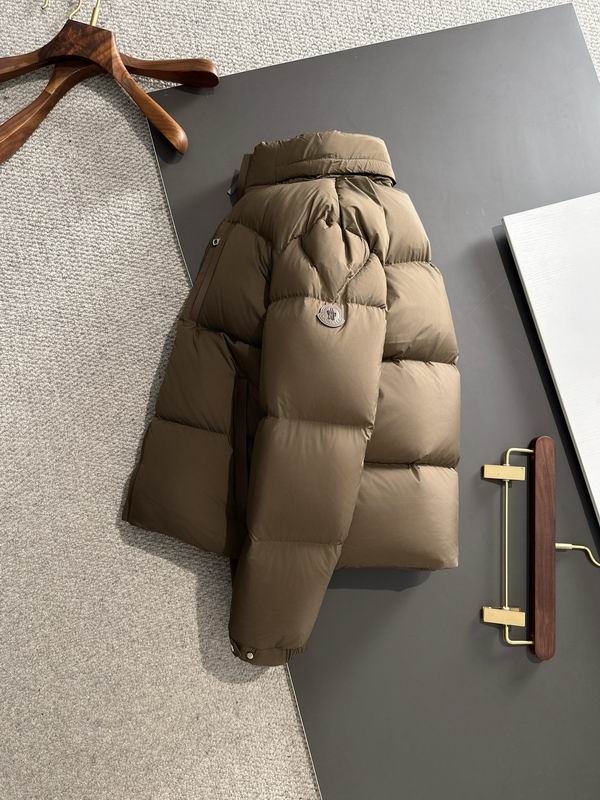 Brown puffer jacket on a dark surface with hangers in the background