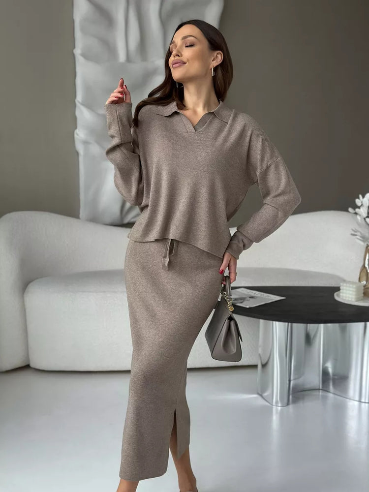 Woman in a beige outfit standing in a modern living room. Chic Elegant Soft Knit Sweater with Skirt Set