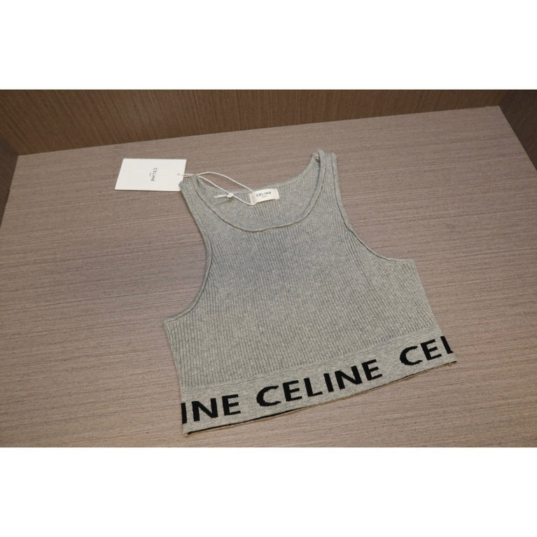 Gray tank top with 'CELINE' branding on a wooden surface
