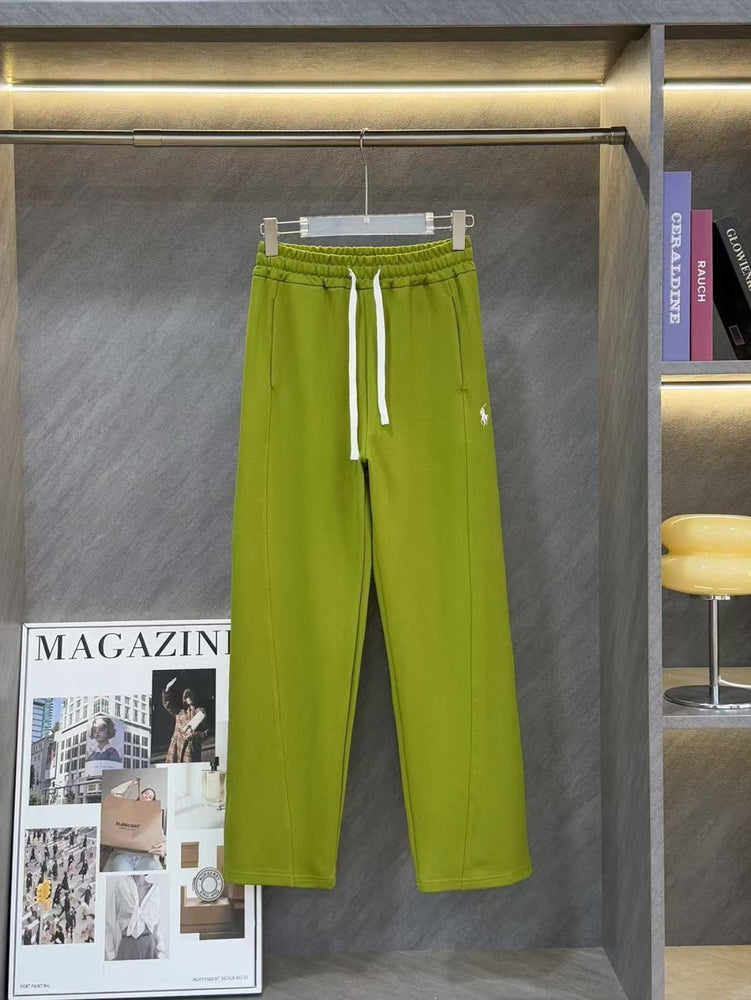 Ralph Lauren Women's Pony Straight Leg Pants. Green sweatpants on a hanger with a magazine and chair in the background