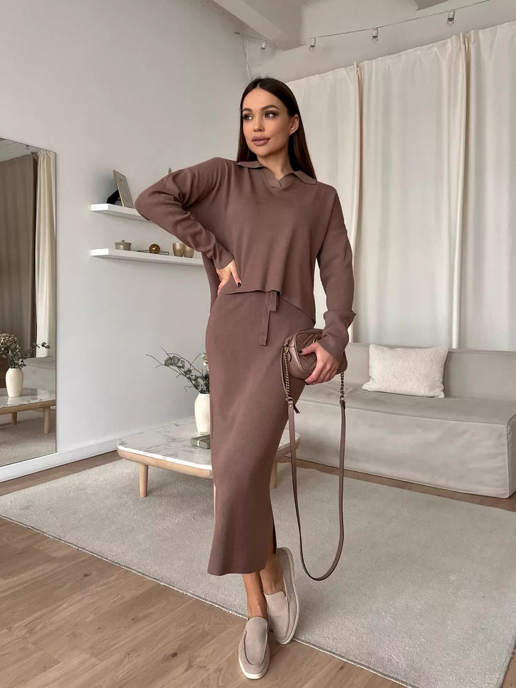 Woman in a brown outfit standing in a modern living room. Chic Elegant Soft Knit Sweater with Skirt Set at Volonka.