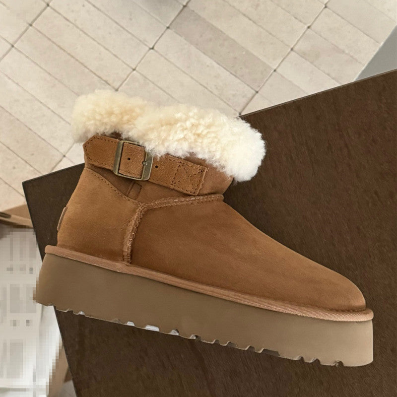 UGG Furry Belted Women's Snow Boot with Thick Platform Sole at Volonka Brown suede boot with white fur lining on a wooden surface