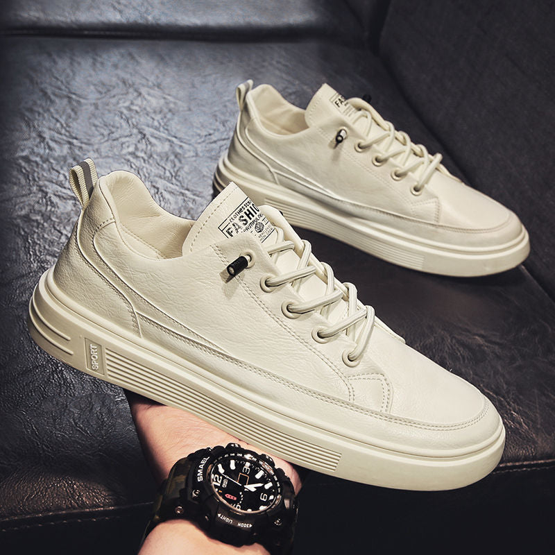 White sneakers being held with a dark background