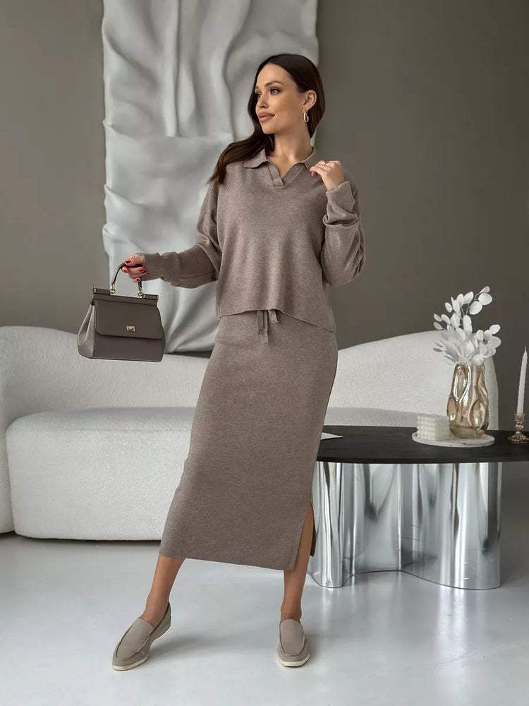 Woman in a gray outfit holding a handbag. Chic Elegant Soft Knit Sweater with Skirt Set