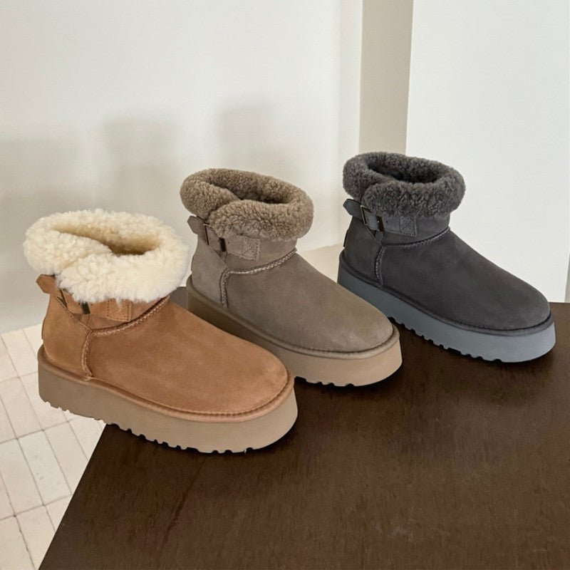 UGG Furry Belted Women's Snow Boot with Thick Platform Sole. Three pairs of winter boots with fur-lined tops on a wooden surface.