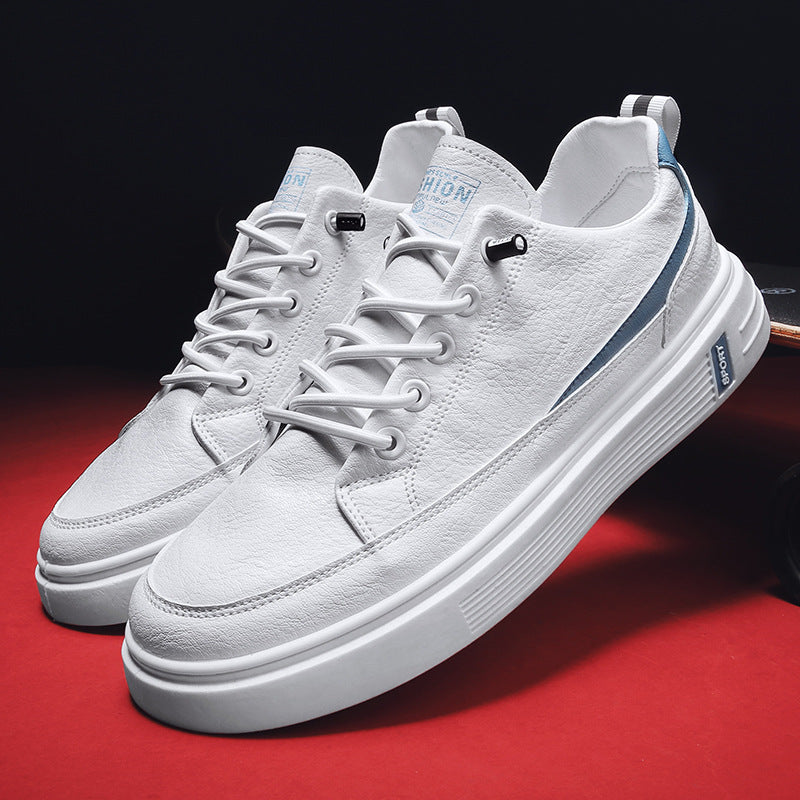 White sneakers with blue accents on a red surface