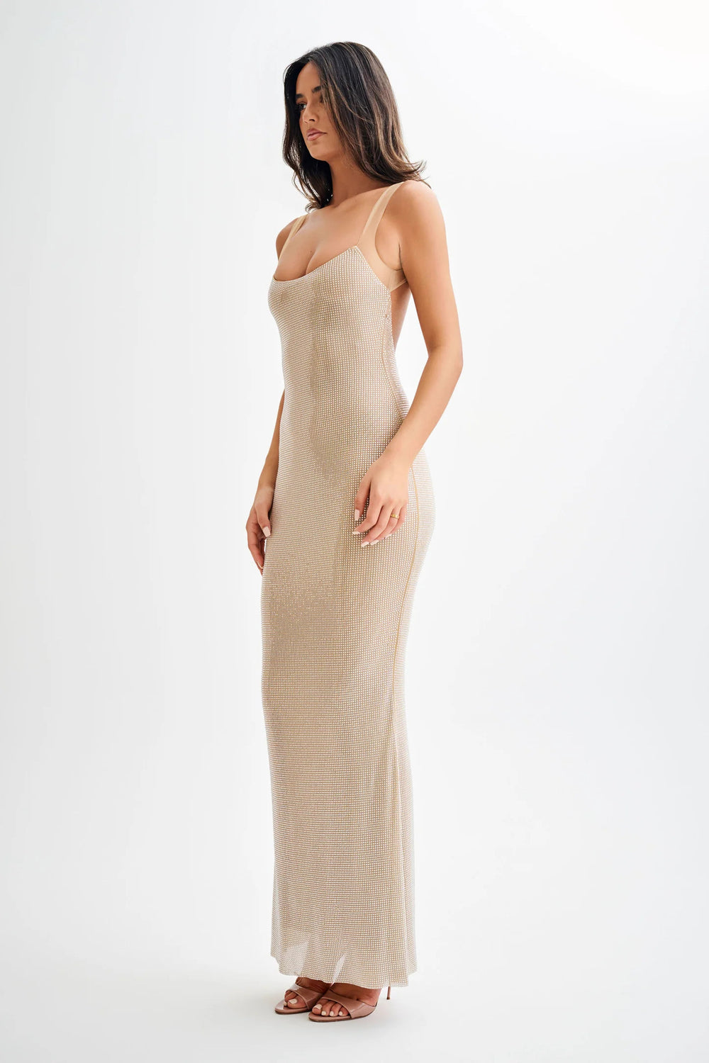 Elegant backless maxi evening dress in a shimmering beige, designed to captivate with a bold, glamorous silhouette.