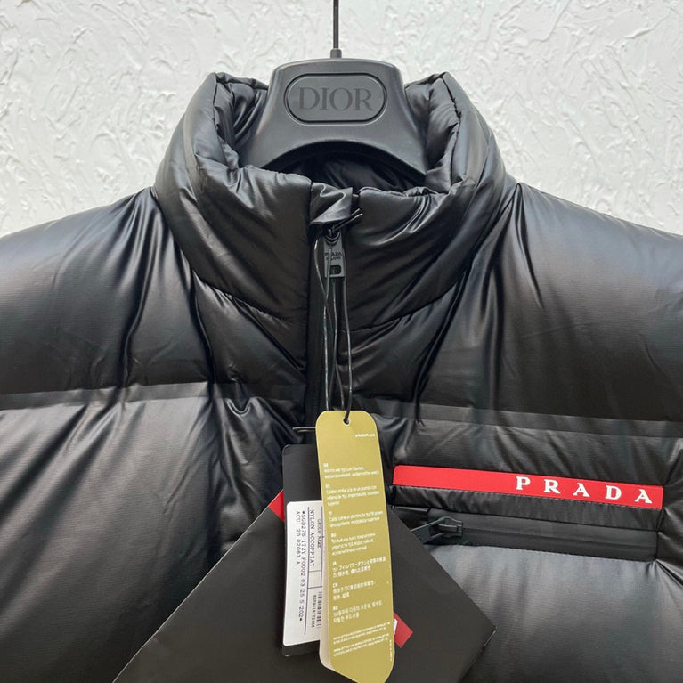 Black puffer jacket with Prada logo on a hanger. Prada Men's light Down Vest jacket