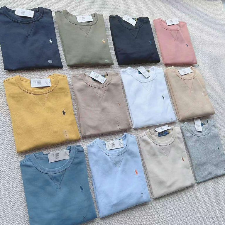 Folded Polo Ralph Lauren sweatshirts arranged in rows in assorted colors like navy, beige, white and blue