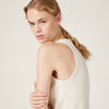 Woman wearing a white tank top in volonka. MIUMIU premium stylish ribbed jersey top