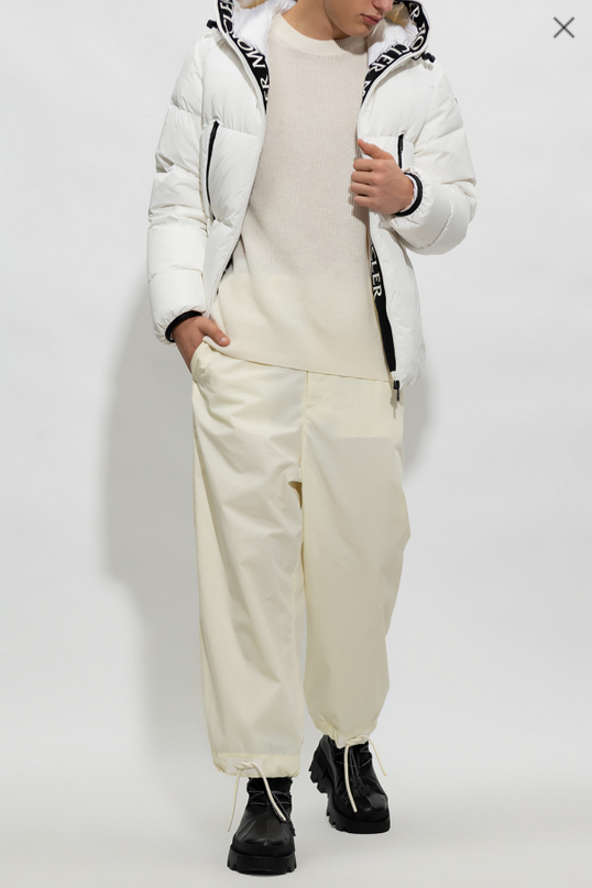 man wearing a white puffer jacket and cream pants. Moncler Montcla Short Down Jacket