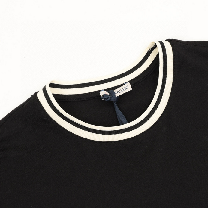 Moncler MC Duck Patchwork Tshirt featuring a playful design detail on a black background.