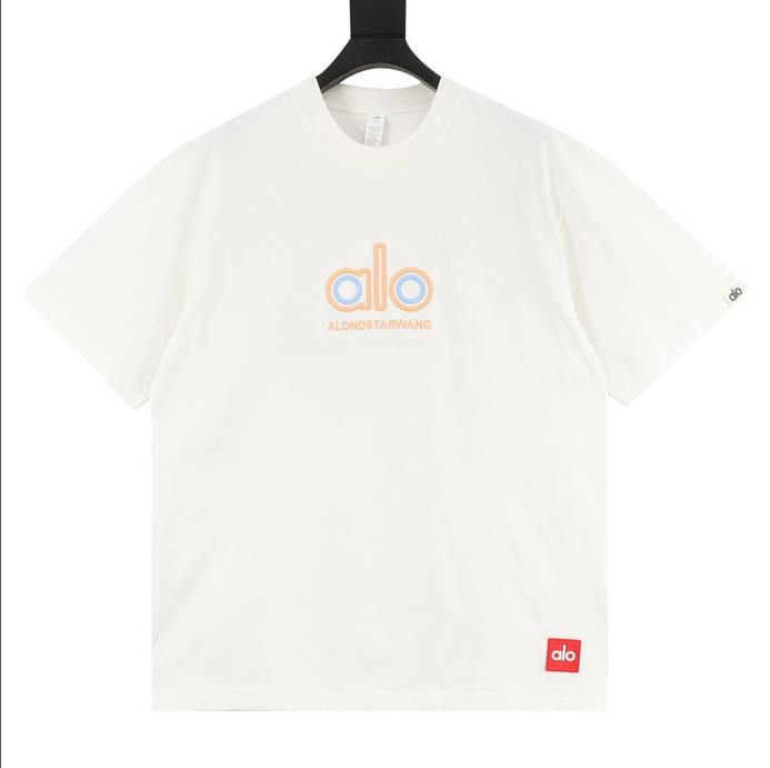 ALO Classic Minimal Short Sleeve Tshirt in white with logo on chest and red tag detail.