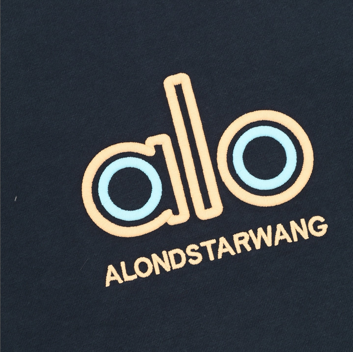 ALO Classic Minimal Short Sleeve Tshirt in navy blue with logo on chest and red tag detail.