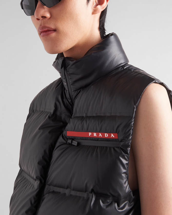 man wearing a black Prada puffer vest. Prada Men's light Down Vest jacket
