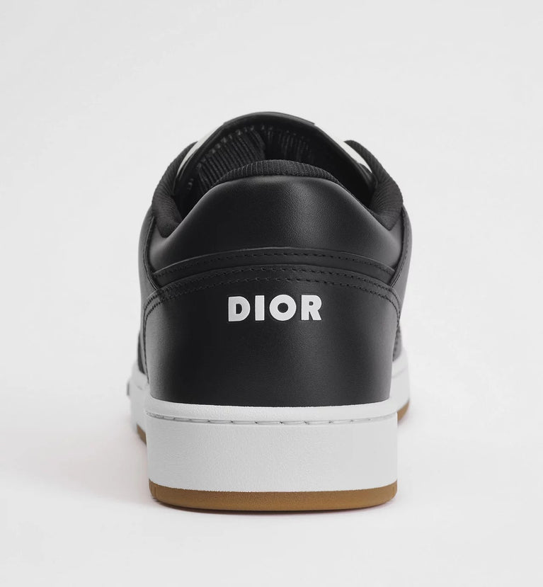 Dior B27 Uptown Low Top Leder Sneaker Black displayed from the side, featuring black leather and a unique design. Dior B27 Uptown Low Top Leder Sneaker Black displayed from the side, featuring black leather and a unique design. at Volonka.