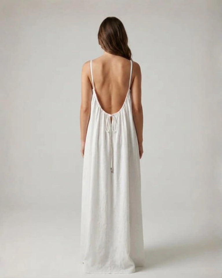 Woman wearing a Backless Loose Home Long Dress in white, showcasing a relaxed and stylish look.