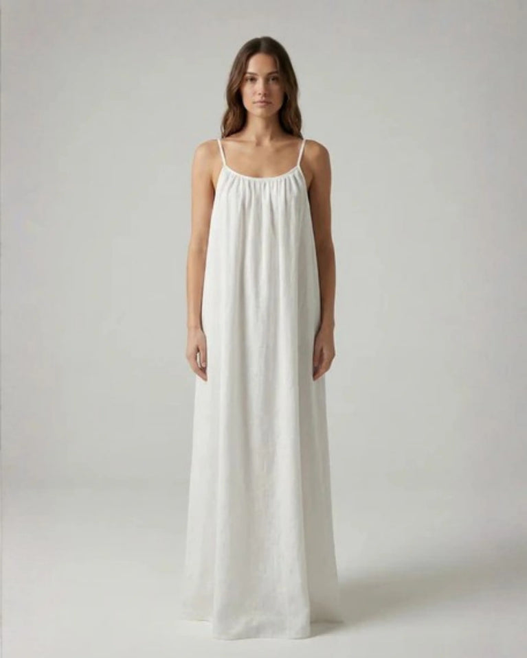 Woman wearing a Backless Loose Home Long Dress in white, showcasing a relaxed and stylish look.