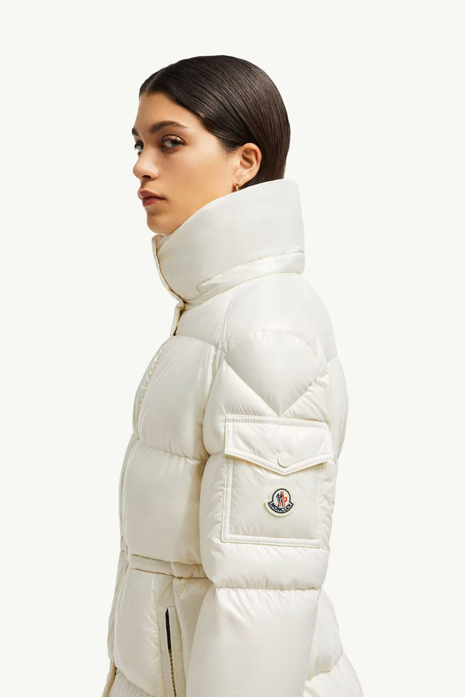 Woman wearing a white puffer jacket with a brand logo, Moncler Cavettaz Hooded Long Down Jacket at volonka