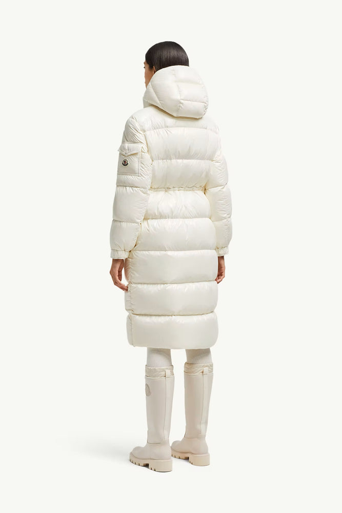 Person wearing Moncler long white puffer coat on a white background