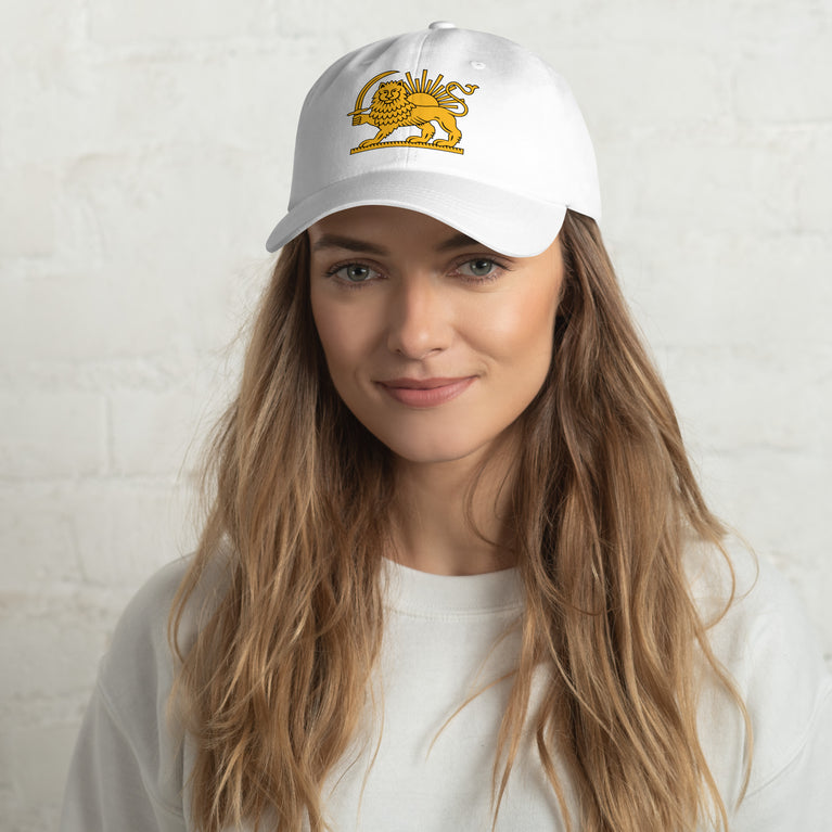 Woman wearing a Shiro Khorshid-Lion Sun Persian Hat with a lion embroidery on a white background.