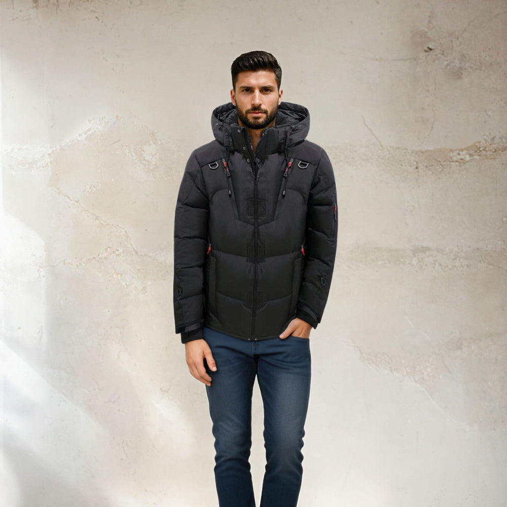 Man wearing a black puffer jacket against a textured beige wall. Men's High Quality Winter Warm Down Jacket