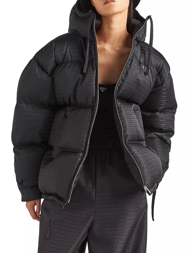 Woman wearing a black puffer jacket. Prada Puffer Down Jacket Unisex at Volonka