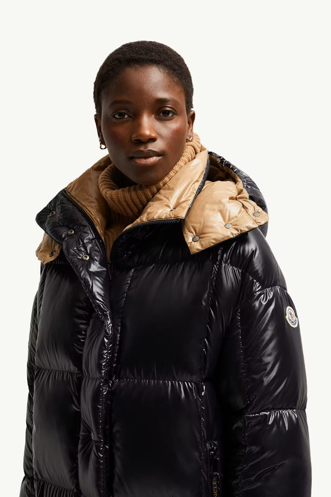 Person wearing a black puffer jacket. Moncler Cavettaz Hooded Long Down Jacket